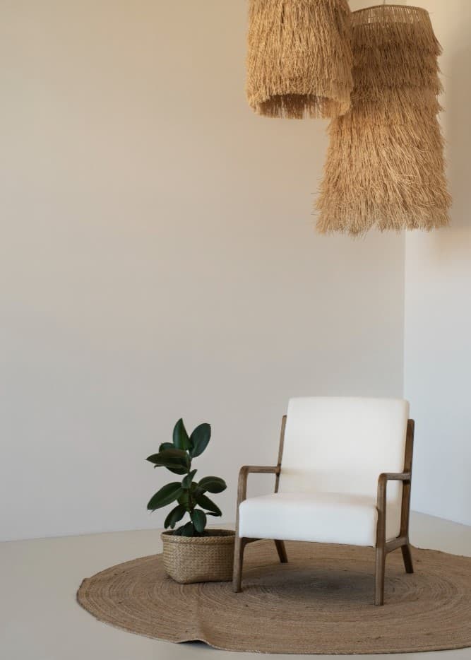 Neutral decor corner with soft textures, greenery, and warm natural materials
