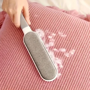 Lint remover brush on pink sweater