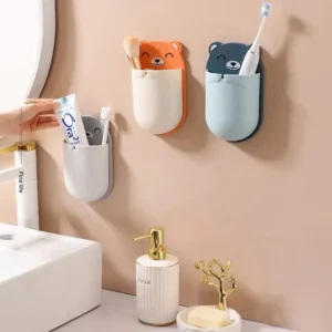 Three colorful bear wall-mounted toothbrush holders in a modern bathroom setting.